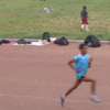 An athlete running around a circular track